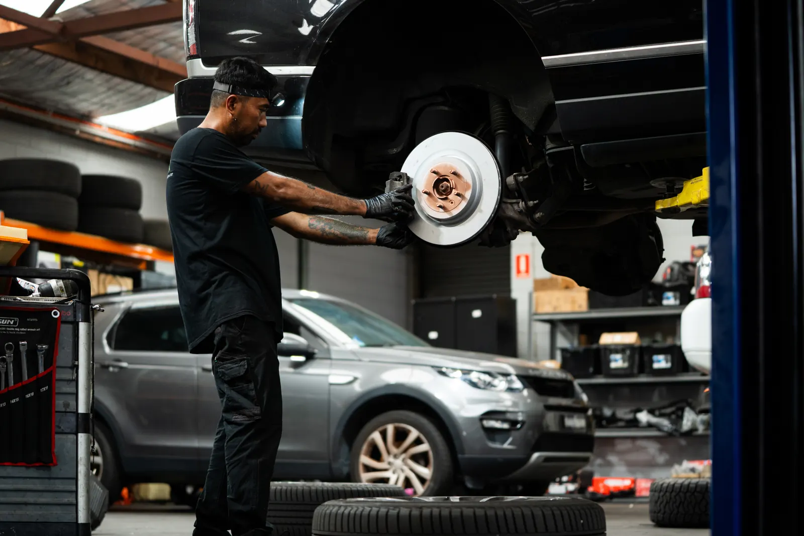 RoverX technician carrying out a brake service in the workshop